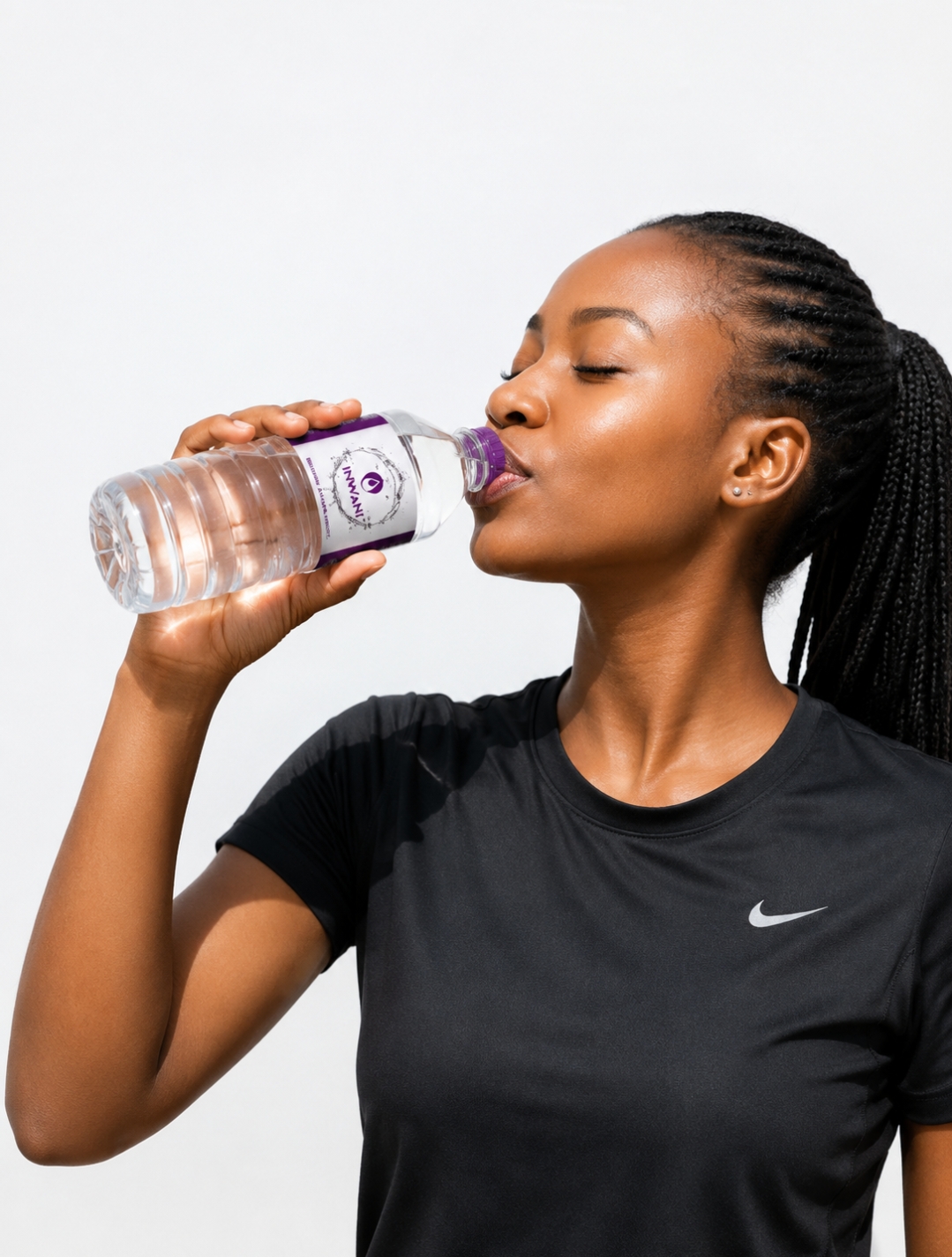 Woman drinking a bottle of Inwani Water